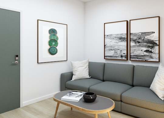 A grey couch with a coffee table in front of it.