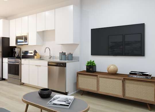 A modern kitchen with stainless steel appliances and white cabinets.