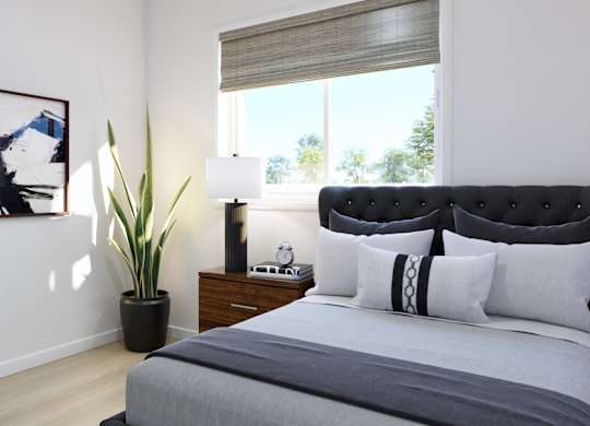 A bedroom with a large bed and a painting on the wall.