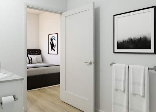 A bathroom with a towel rack and a picture on the wall.