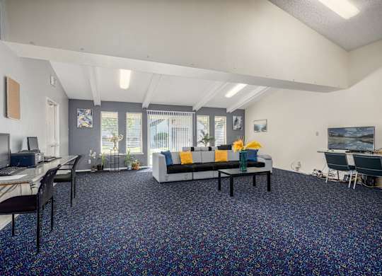 A room with a blue carpet and a white ceiling.