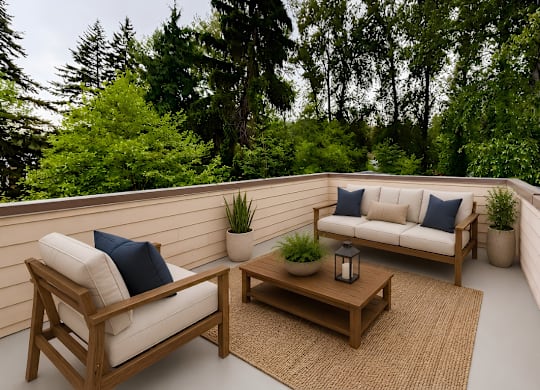 A wooden chair and table with cushions and potted plants on a balcony.
