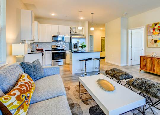 a living room and kitchen with a couch and a table at Solo at North Bergen, North Bergen