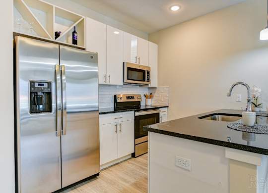 a kitchen with stainless steel appliances and a counter top at Solo at North Bergen, North Bergen