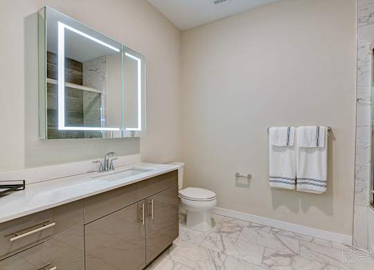 a bathroom with a mirror and a sink and a toilet at Solo at North Bergen, New Jersey