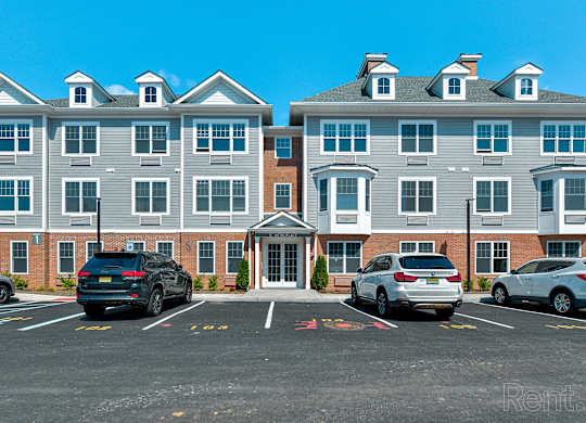 a parking lot in front of a large apartment building at Solo at North Bergen, North Bergen