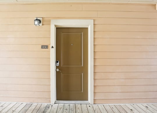 the front door of a house with a brown door