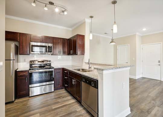 a kitchen with wooden cabinets and stainless steel appliances