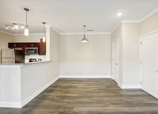 a renovated living room with white walls and wood flooring