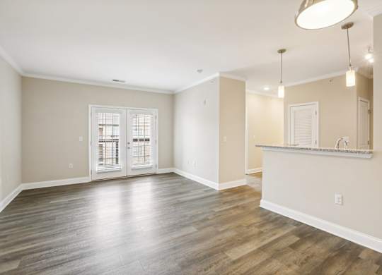 the living room and kitchen of a new home with wood flooring