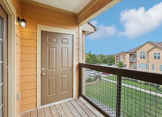 the view from the deck of a home with a door to the yard