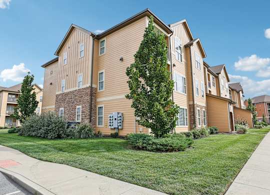 our apartments are located on the corner of a street with grass