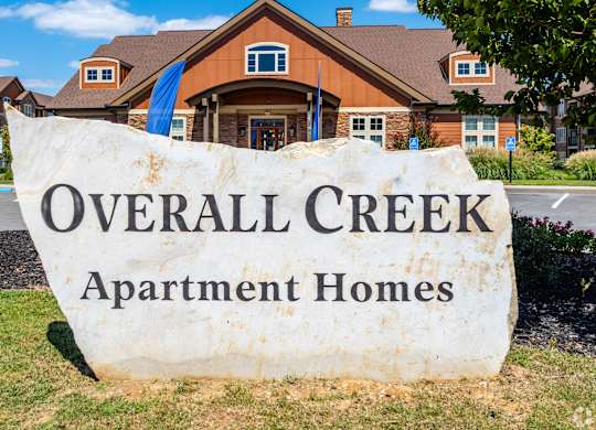 an overhead creek apartment homes sign in front of a house