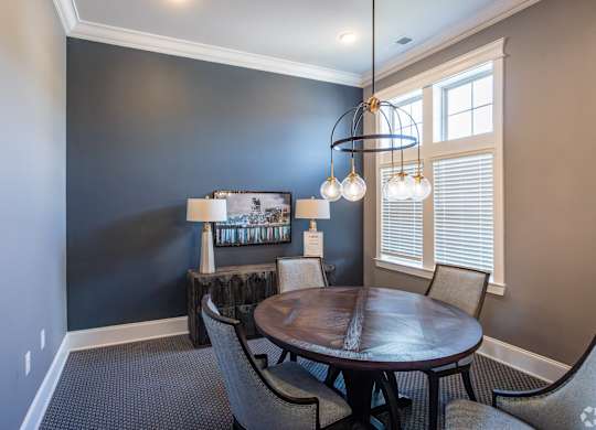 a dining room with a table and chairs and a chandelier