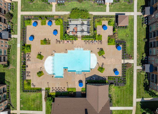an overhead view of a building with a pool in the middle