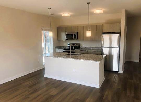 Kitchen island with granite countertops at Novi Lofts in Concord, NC