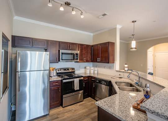 a kitchen with stainless steel appliances and granite counter tops
