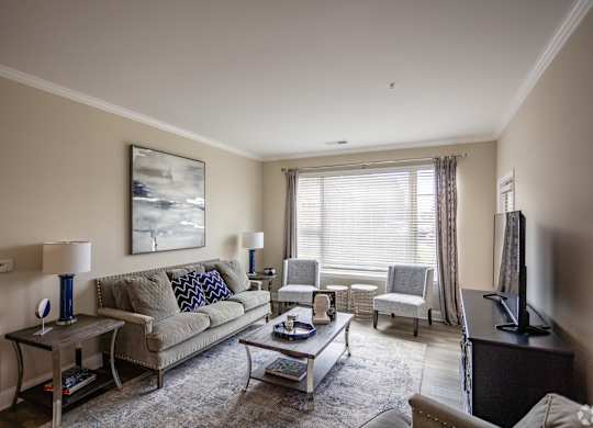 a living room with a couch and chairs and a table