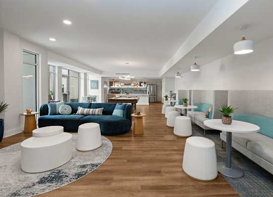 A modern living room with a long couch and a white coffee table.