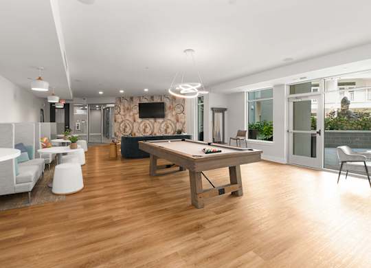 A modern living room with a wooden floor and furniture.
