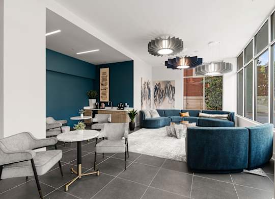 A modern living room with a grey sofa and a white coffee table.