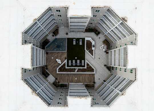 A top down view of a building with a central staircase and surrounding walkways.