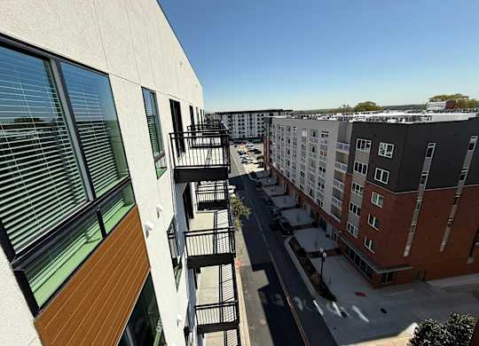 A view of a street with buildings on either side.