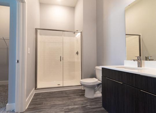 Bathroom with glass shower doors at Novi Flats
