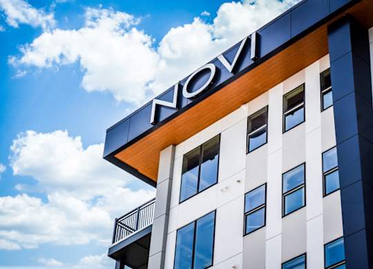 Novi sign on the exterior of Novi Flats Apartments in downtown Concord, NC