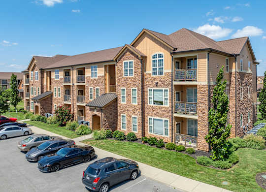 an apartment building with cars parked in front of it