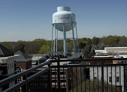 A white water tower with the word Concord on it.