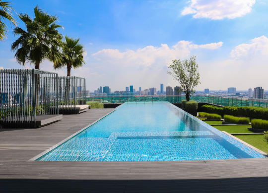 the infinity pool on the roof of a skyscraper overlooking the city