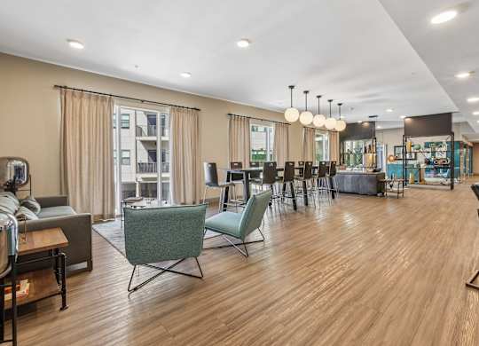 A spacious living room with wooden floors and a variety of seating options.