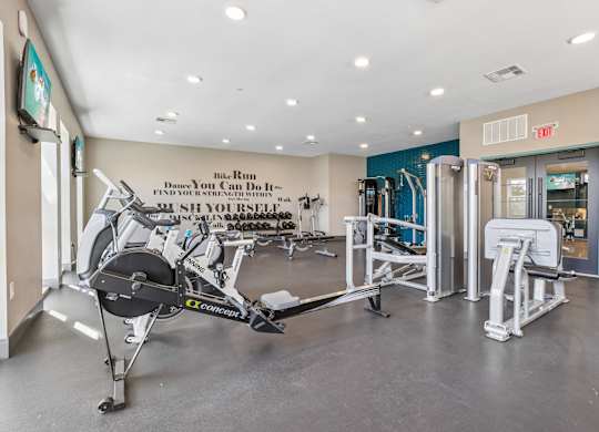 A gym with a row of exercise bikes and a sign that says "Ride. Ride. Ride."