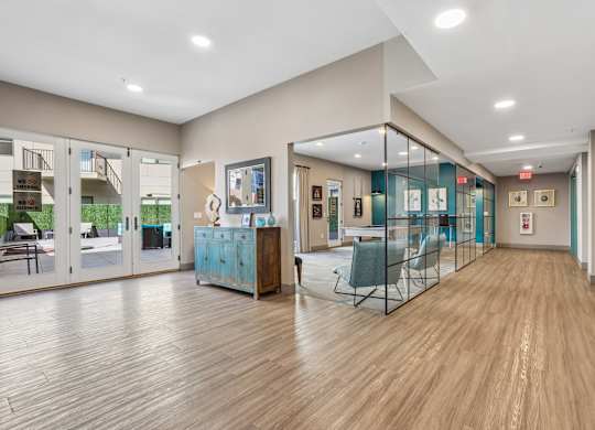 A spacious room with wooden floors and glass walls.
