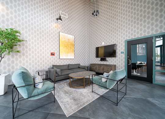 A living room with a grey sofa, a green chair and a television at Crossroads 389 Apartments, Hackensack 07601