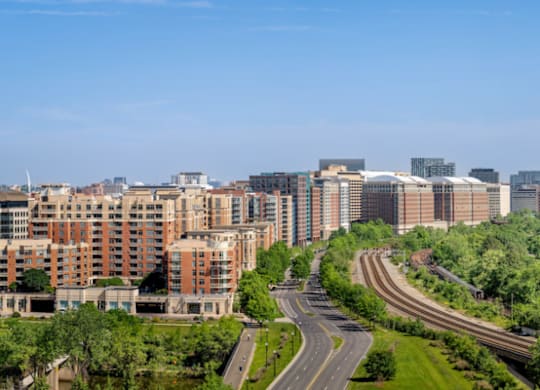 A curvy road with a green grassy area on the side.