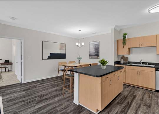 A kitchen with wooden cabinets and a black countertop.
