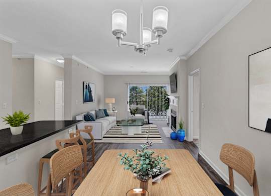 A modern dining room with a wooden table and chairs.