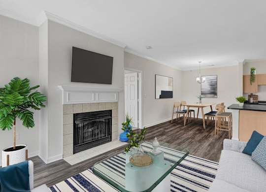 A living room with a fireplace and a television above it.