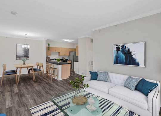 A living room with a white couch and a coffee table in the center.