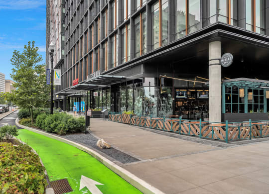 a sidewalk in front of a building with a dog
