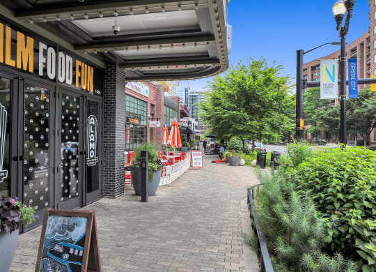 a brick sidewalk with a building with a sign that reads fish food box