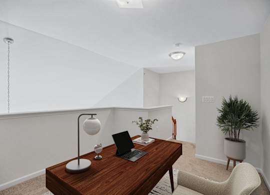 A modern home office with a laptop on a desk.