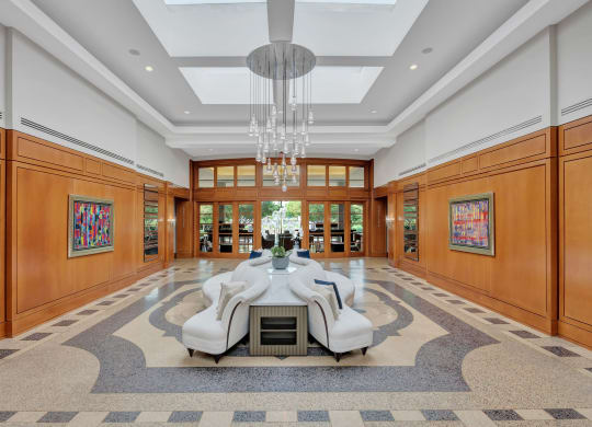 a dining room with a large table and chairs in the middle of a large room
