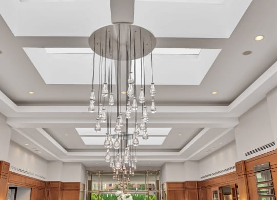 a view of a dining room with a large chandelier and a large ceiling