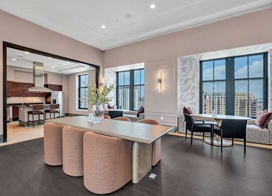A modern living room with a large table and chairs.