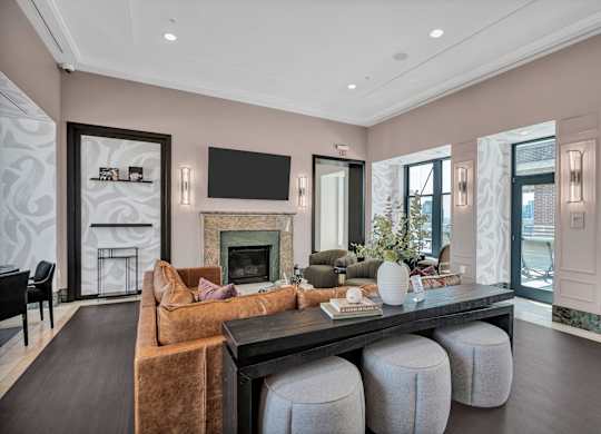 A living room with a fireplace and a television on the wall.