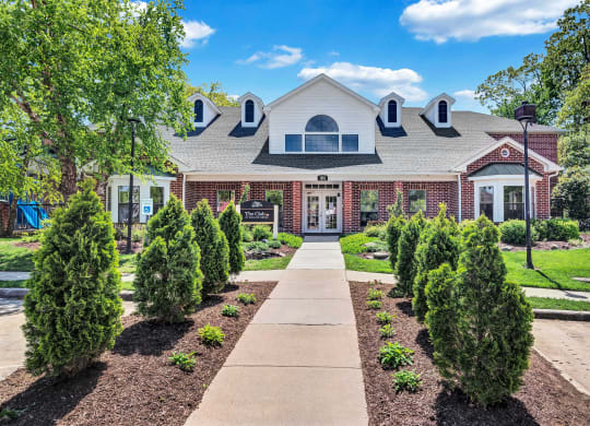 a home with a walkway leading to the front door