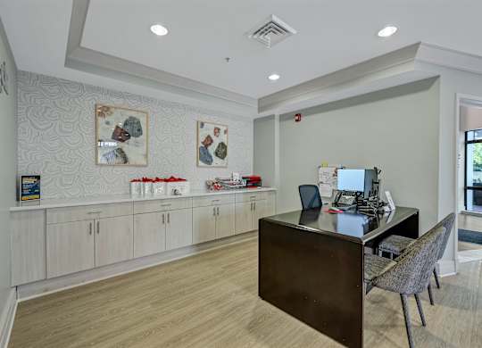 A modern office space with a desk, chair, and computer.